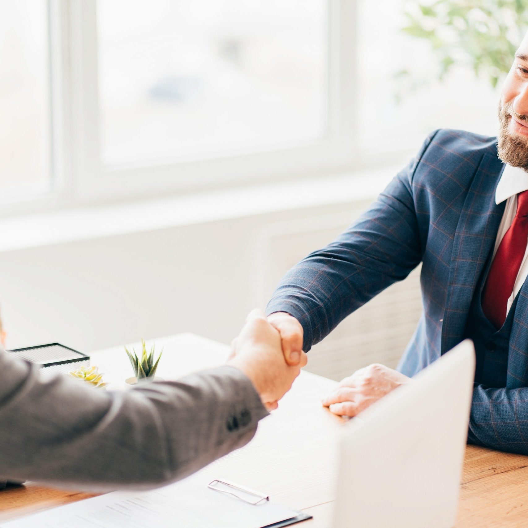 Successful negotiation, deal, office meeting. Business partners handshaking after deal or interview. Hiring and career concept