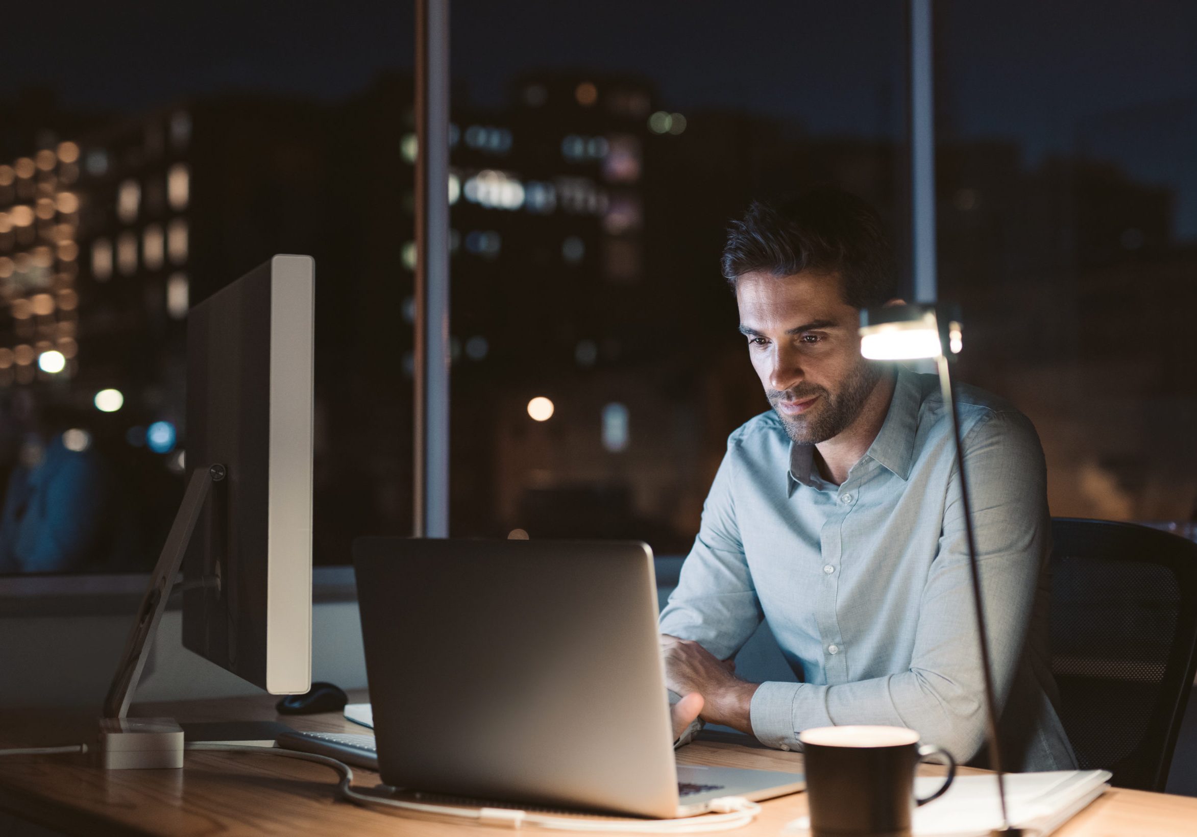 Young businessman working overtime late in the evening